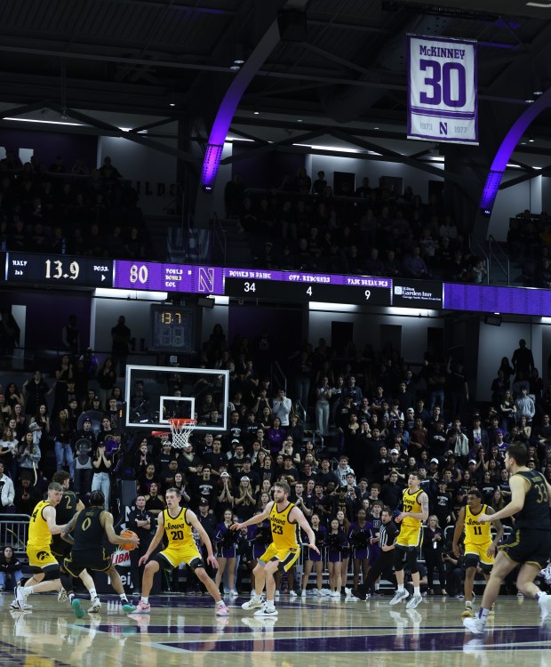 The No. 30 of former Northwestern player Billy McKinney is seen hanging from the rafters as Northwestern and Iowa battle late in the second half at Welsh-Ryan Arena in Evanston on March 2, 2024. Northwestern held a ceremony at halftime to retire McKinney's number 30. (Chris Sweda/Chicago Tribune)