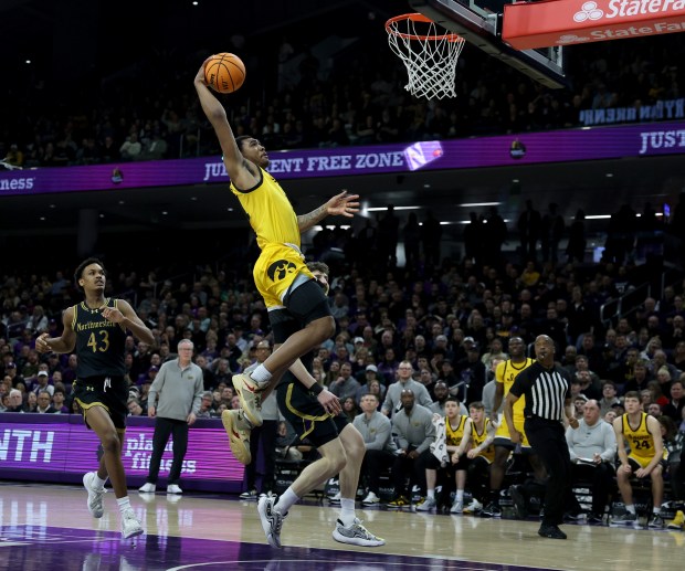 Iowa guard Tony Perkins (11) goes in for a dunk in the second half against Northwestern at Welsh-Ryan Arena in Evanston on March 2, 2024. (Chris Sweda/Chicago Tribune)