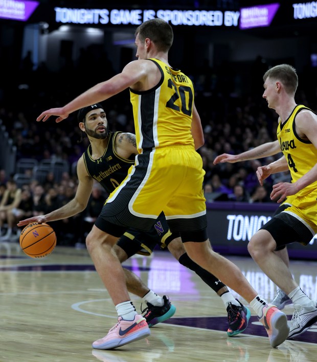 Northwestern guard Boo Buie (0) looks for an open teammate in the first half against Iowa at Welsh-Ryan Arena in Evanston on March 2, 2024. (Chris Sweda/Chicago Tribune)