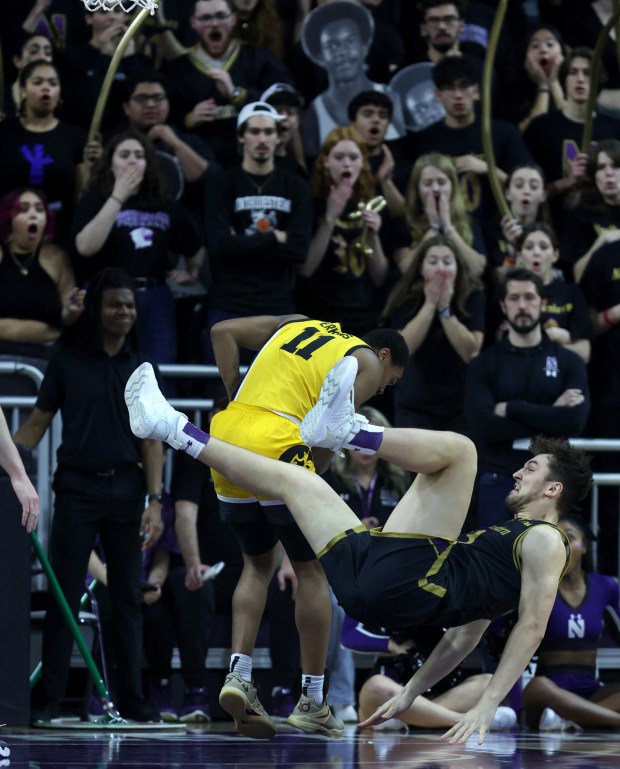 Northwestern forward Luke Hunger (33) falls to the floor in the first half against Iowa at Welsh-Ryan Arena in Evanston on March 2, 2024. (Chris Sweda/Chicago Tribune)