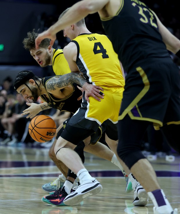 Northwestern guard Boo Buie (0) loses possession in the first half against Iowa at Welsh-Ryan Arena in Evanston on March 2, 2024. (Chris Sweda/Chicago Tribune)