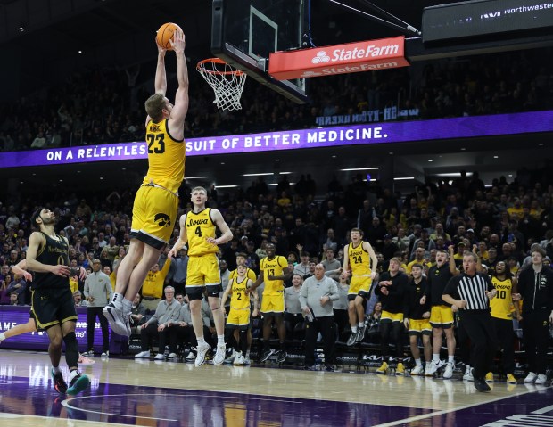 Iowa forward Ben Krikke dunks in front of Northwestern guard Boo Buie (0) in the second half at Welsh-Ryan Arena in Evanston on March 2, 2024. (Chris Sweda/Chicago Tribune)