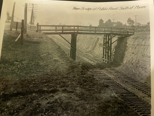 A wooden bridge traverses the freshly dug "Cut" in Monee in this undated photo provided by the Monee Historical Society. Work on the railroad project wrapped up in 1923. (Monee Historical Socety)