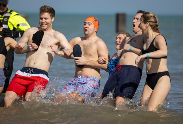 Participants take a dip in Lake Michigan on a warm morning during the 24th Annual Chicago Polar Plunge, Sunday, March 3, 2024, at North Avenue Beach. (Brian Cassella/Chicago Tribune)
