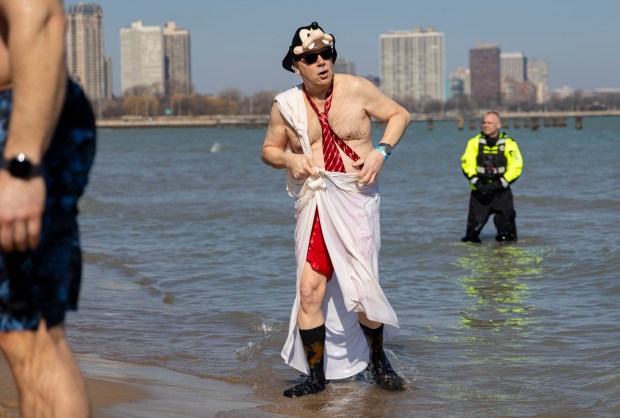 Costumed participants take a dip in Lake Michigan on a warm morning during the 24th Annual Chicago Polar Plunge, Sunday, March 3, 2024, at North Avenue Beach. (Brian Cassella/Chicago Tribune)