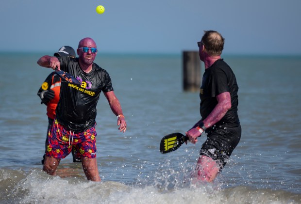 Participants play pickle ball while taking a dip in Lake Michigan on a warm morning during the 24th Annual Chicago Polar Plunge, Sunday, March 3, 2024, at North Avenue Beach. (Brian Cassella/Chicago Tribune)