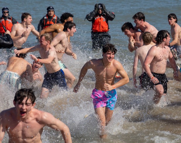 Participants take a dip in Lake Michigan on a warm morning during the 24th Annual Chicago Polar Plunge, Sunday, March 3, 2024, at North Avenue Beach. (Brian Cassella/Chicago Tribune)