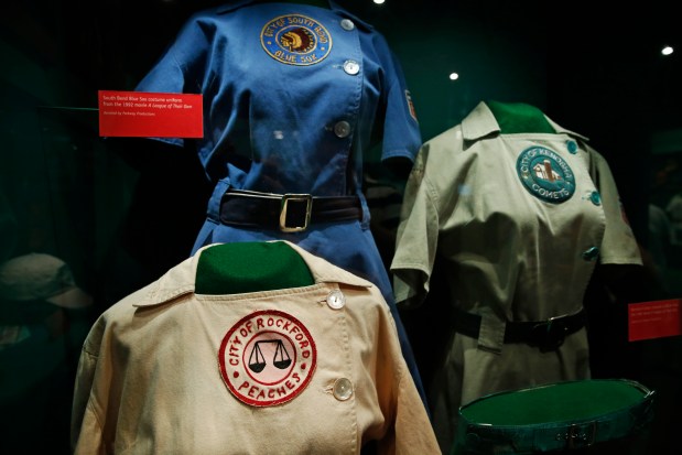 The Rockford Peaches costume uniform worn by Geena Davis as Dottie Hinson, and a South Bend Blue Sox costume uniform from the 1992 movie "A League of Their Own" and other movie items seen here displayed with other items from the film at the Baseball Hall of Fame in Cooperstown on July 15, 2014. (Jose M. Osorio/ Chicago Tribune)