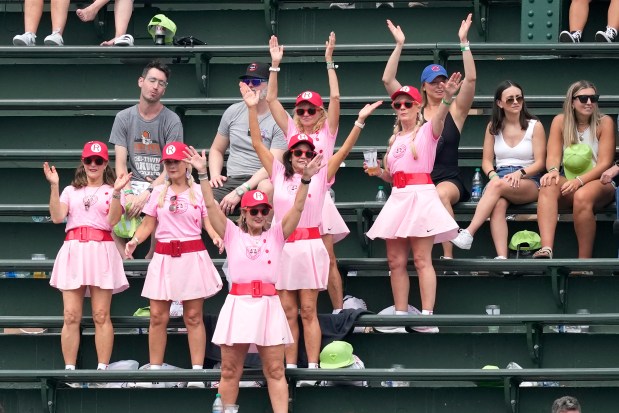 Women dressed as Rockford Peaches from the movie "A League of Their Own," dance in the bleachers at Wrigley Field on June 30, 2023 (Charles Rex Arbogast/AP photo)