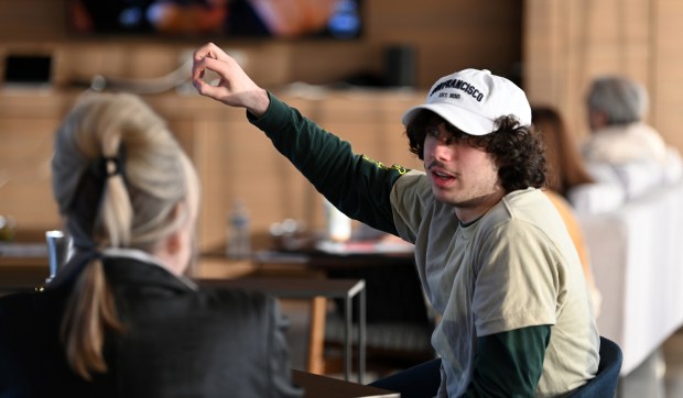 Right arm raised, Josh Spinner, 19, of Glencoe, of the New Trier Township High School Class of 2022, is among attendees at the annual WLC annual Oscars Viewing Party at Writers Theatre in Glencoe on March 10, 2024. (Karie Angell Luc/Pioneer Press)