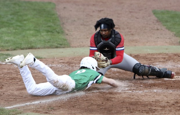 St Rita's Sir Jamison Jones blocks Providence's Nate Scialabba at the plate during a Catholic League Blue game in New Lenox on Monday, April 11, 2022.