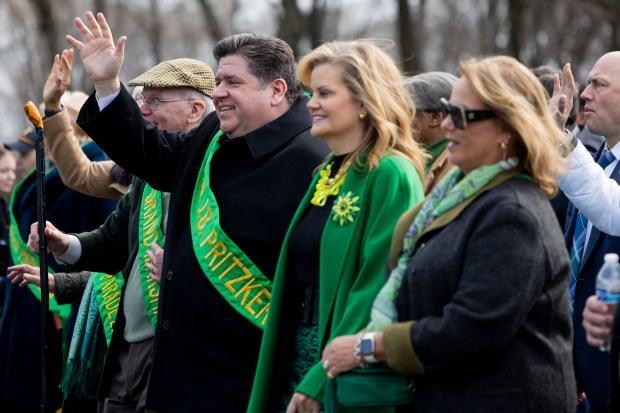 Illinois Gov. J.B. Pritzker and first lady M.K. Pritzker wave to the crowd during the annual St. Patrick's Day Parade, March 16, 2024, in downtown Chicago. (Vincent Alban/Chicago Tribune)