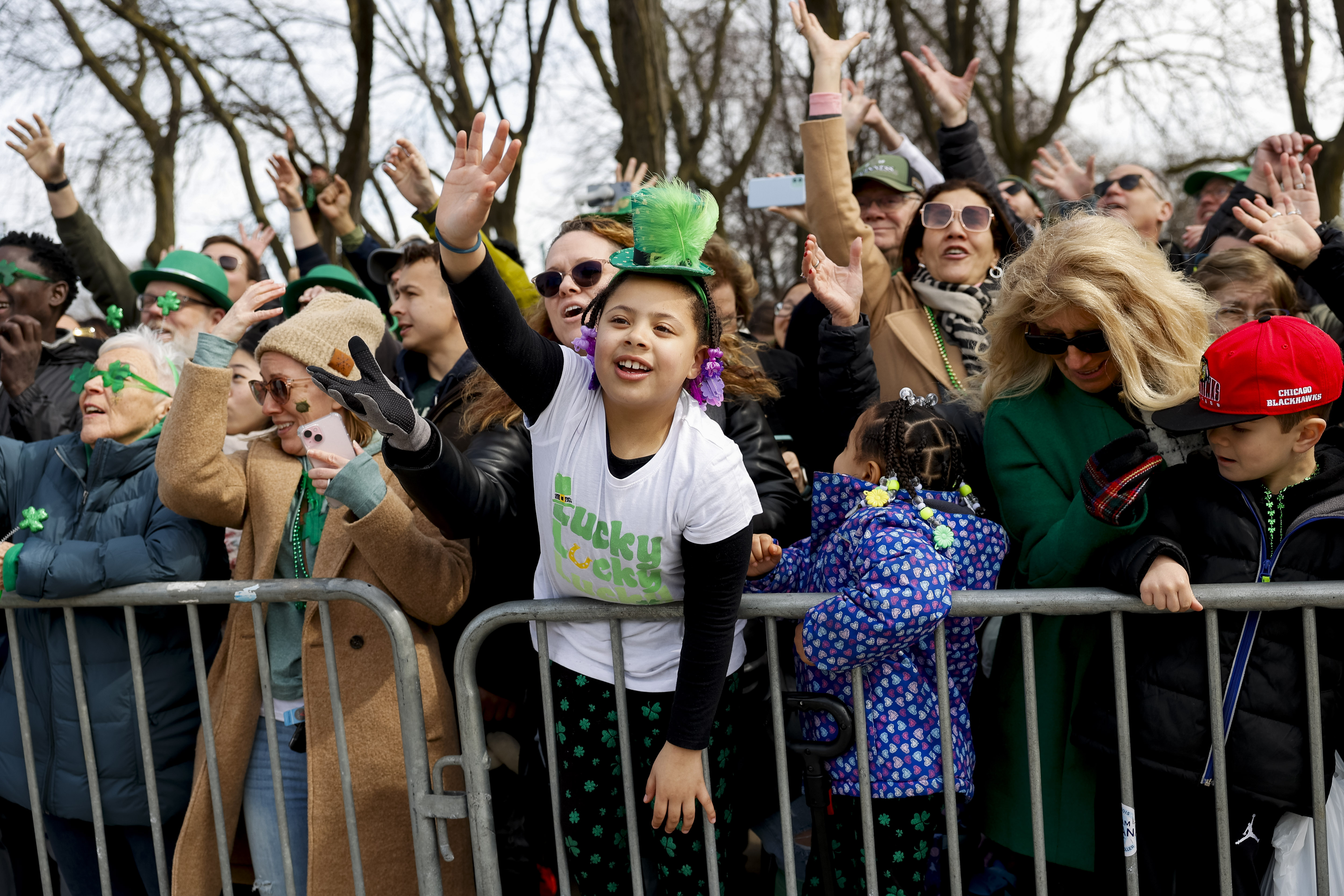 A young spectator waves during the annual St. Patrick's Day Parade, March 16, 2024, in Chicago. (Vincent Alban/Chicago Tribune)