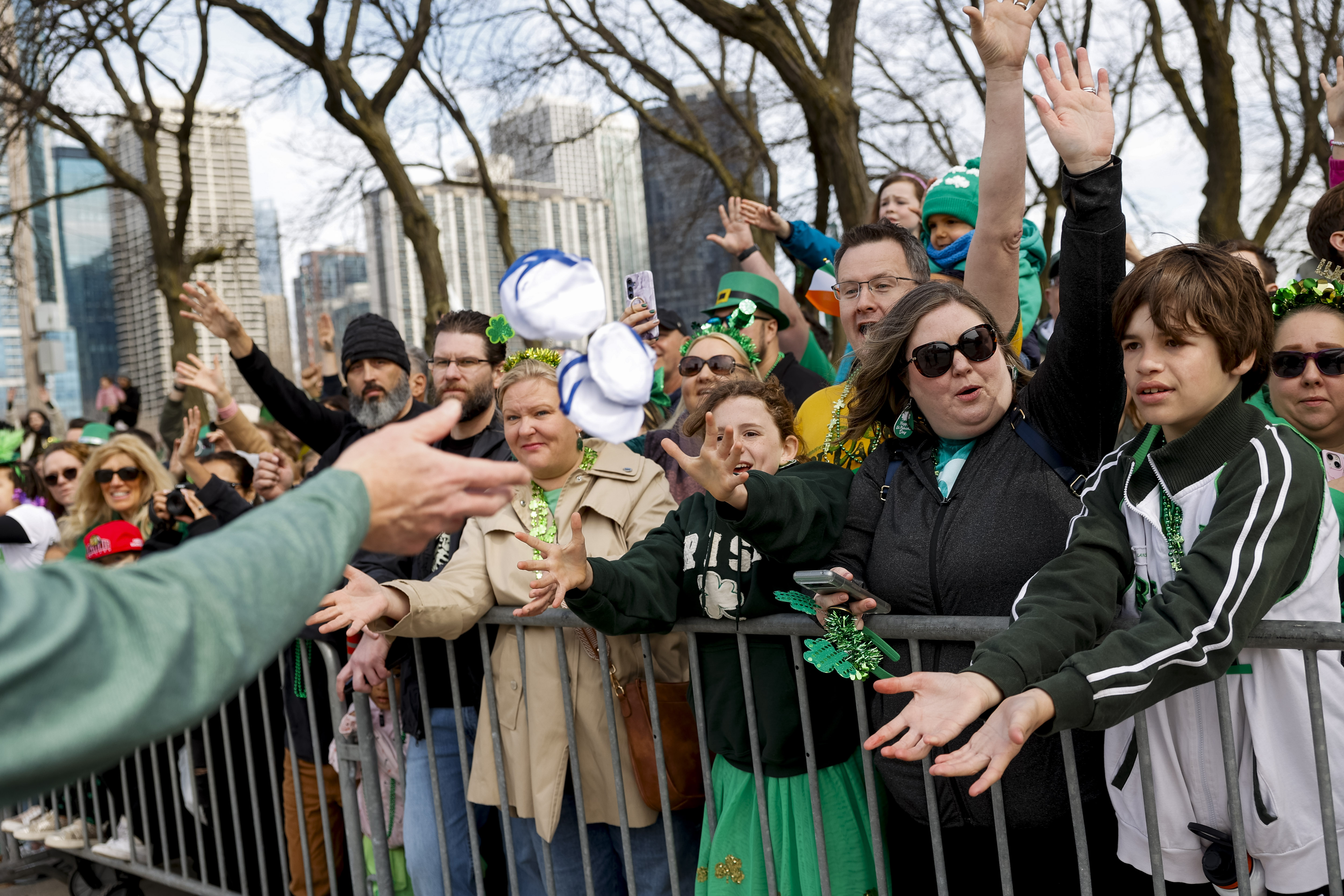 Spectators attempt to catch give away items during the annual St. Patrick's Day Parade, March 16, 2024, in Chicago. (Vincent Alban/Chicago Tribune)