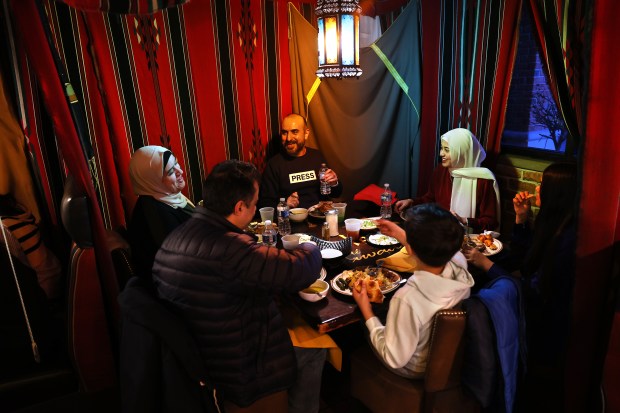 The Rasoul family of Orland Park relaxes at Al Bawadi Grill in Bridgeview during the Iftar while celebrating Ramadan on Friday, March 15, 2024. (Chris Sweda/Chicago Tribune)