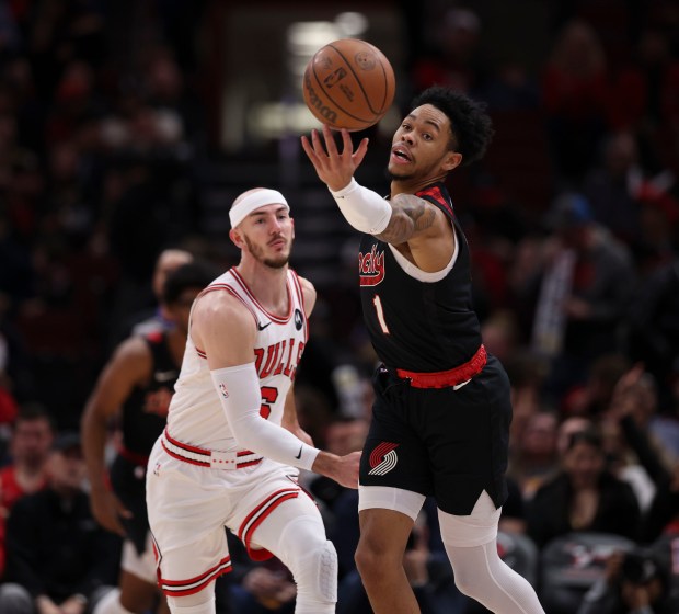 Portland Trail Blazers guard Anfernee Simons (1) chases a pass against Chicago Bulls guard Alex Caruso (6) in the first half Monday, March 18, 2024, at the United Center. (Brian Cassella/Chicago Tribune)