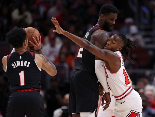 Chicago Bulls guard Ayo Dosunmu (12) runs into Portland Trail Blazers center Deandre Ayton (2) while defending guard Anfernee Simons (1) in the first half Monday, March 18, 2024, at the United Center. (Brian Cassella/Chicago Tribune)
