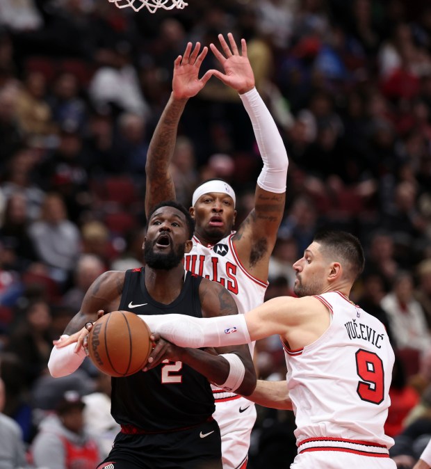 Chicago Bulls center Nikola Vucevic (9) defends Portland Trail Blazers center Deandre Ayton (2) in the second half Monday, March 18, 2024, at the United Center. (Brian Cassella/Chicago Tribune)