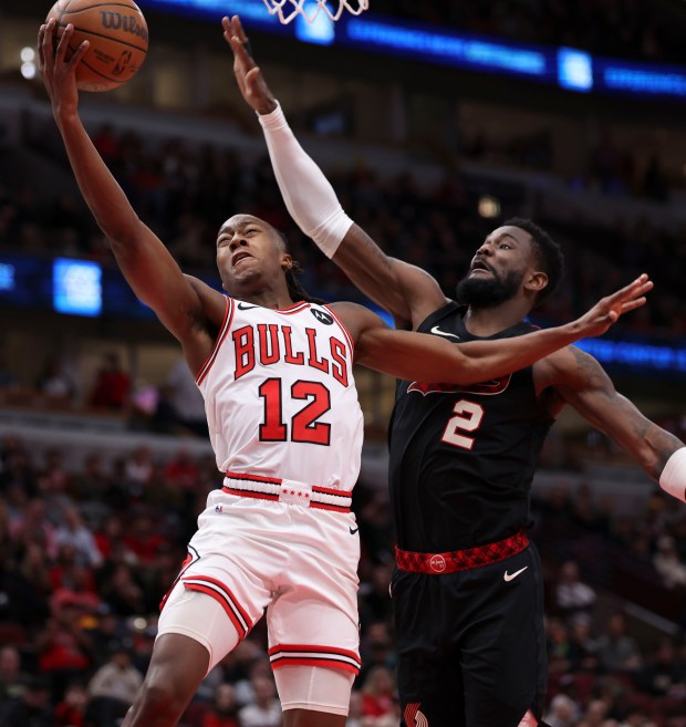 Chicago Bulls guard Ayo Dosunmu (12) shoots against Portland Trail Blazers center Deandre Ayton (2) in the first half Monday, March 18, 2024, at the United Center. (Brian Cassella/Chicago Tribune)