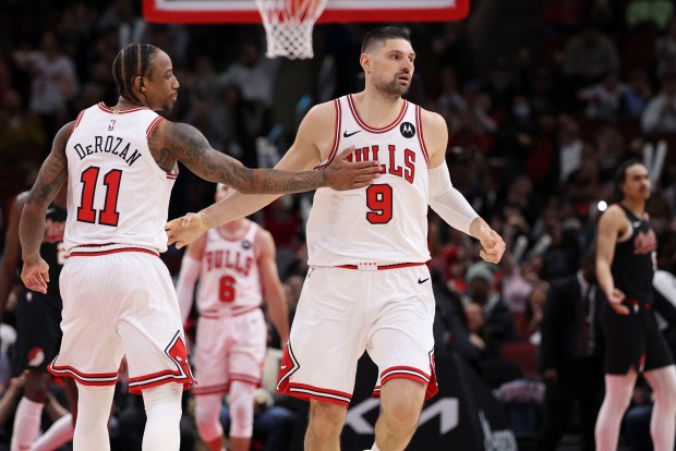 Chicago Bulls forward DeMar DeRozan (11) and center Nikola Vucevic (9) celebrate late in the second half Monday, March 18, 2024, at the United Center. (Brian Cassella/Chicago Tribune)