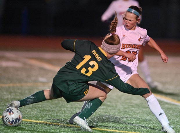 Naperville North's Emily Buescher (25) defends against Fremd's Lily Mayer (13) during the 1st half of Monday's game, March 18, 2024. The game ended in a scoreless tie. (Brian O'Mahoney for the Naperville Sun)
