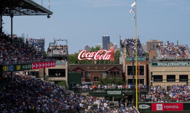The Chicago Cubs are asking aldermen to allow team owners to install LED rooftop signs on two buildings outside Wrigley Field. The team would like to install a Coca-Cola sign atop 1040 W. Waveland Ave., as shown in this rendering. (Stratus and Cicago Cubs)