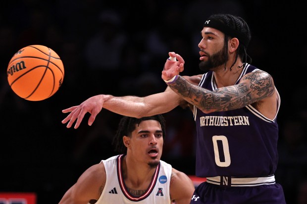 Northwestern's Boo Buie passes in the first half against Bryan Greenlee of Florida Atlantic on March 22, 2024, at the Barclays Center in New York. (Elsa/Getty)