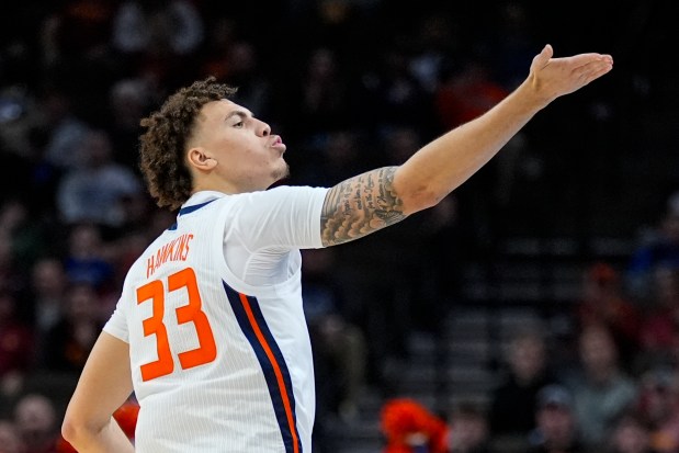 Illinois forward Coleman Hawkins (33) blows a kiss to the crowd after hitting a 3-pointer against Duquesne in the NCAA Tournament on March 23, 2024, in Omaha, Neb. (Charlie Neibergall/AP)