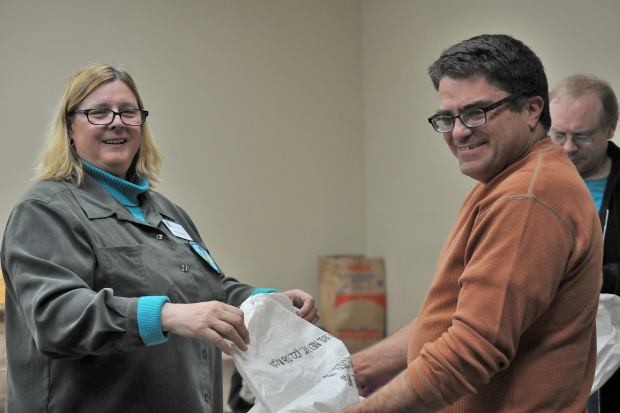 Marnie Baker and Mike Kline fill a seed bag Nov. 7, 2017. (Jeanne Stacey)