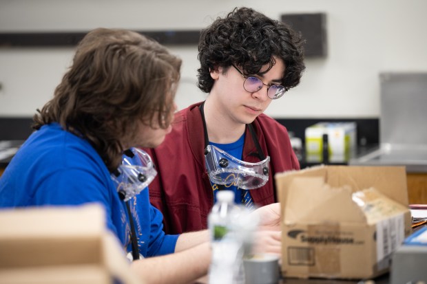 Highland High School seniors David Alvarado, on right, and Jakob Mikolajczyk work on calculations during the wind lab portion of the Science Olympiad state tournament at Purdue University Northwest in Hammond on Saturday, March 23, 2024. (Kyle Telechan/for the Post-Tribune)