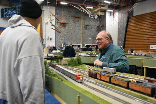 Bob Kosic, with a Mod-U-Trak setup featuring a Santa Fe train line setup, explains his models to visitors to the train show on Saturday at the LTHS gym. (Jesse Wright)