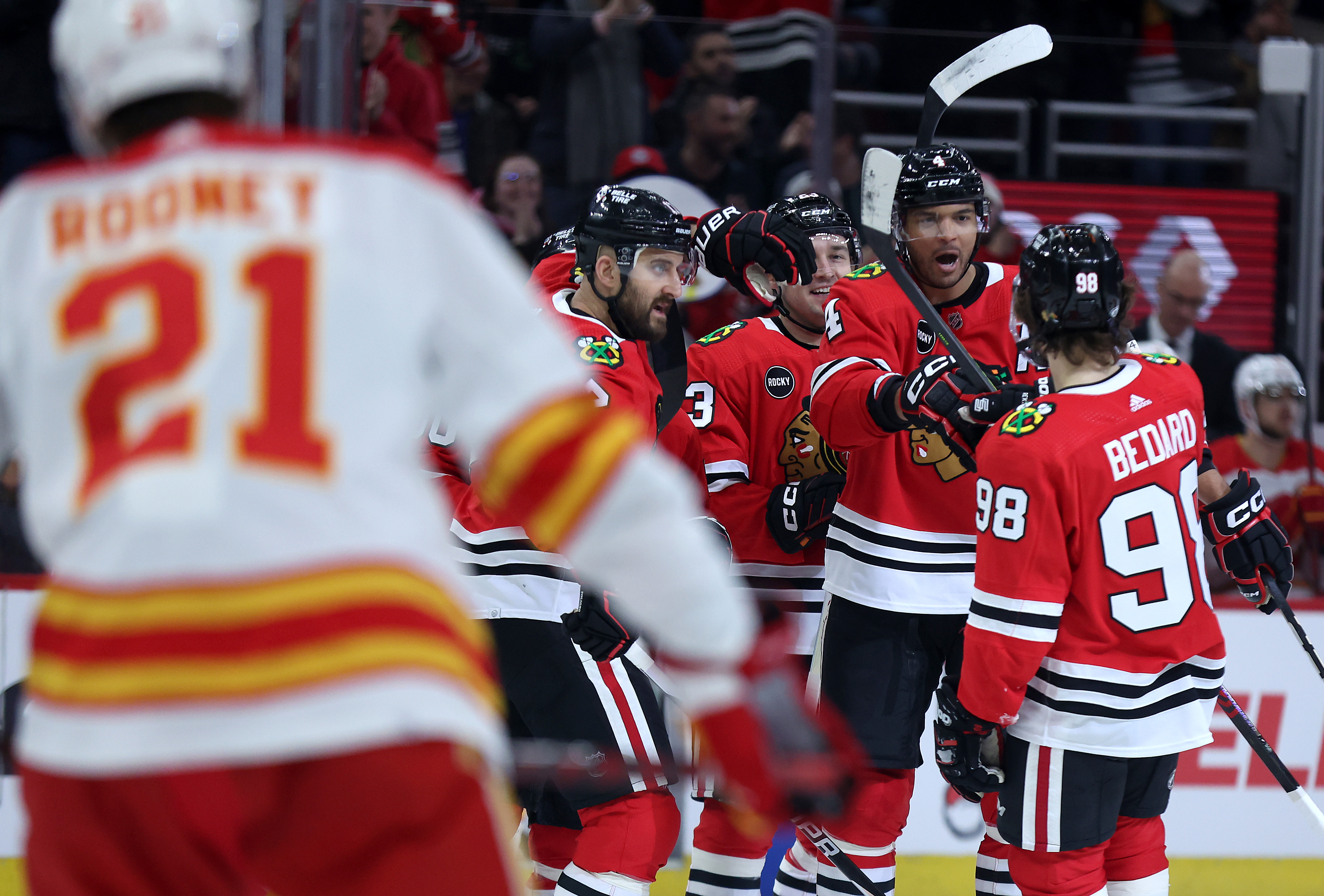 Chicago Blackhawks defenseman Seth Jones (right) celebrates with his teammates, including center Connor Bedard (98), after Jones scored goal in the first period of a game against the Calgary Flames at the United Center in Chicago on March 26, 2024. (Chris Sweda/Chicago Tribune)