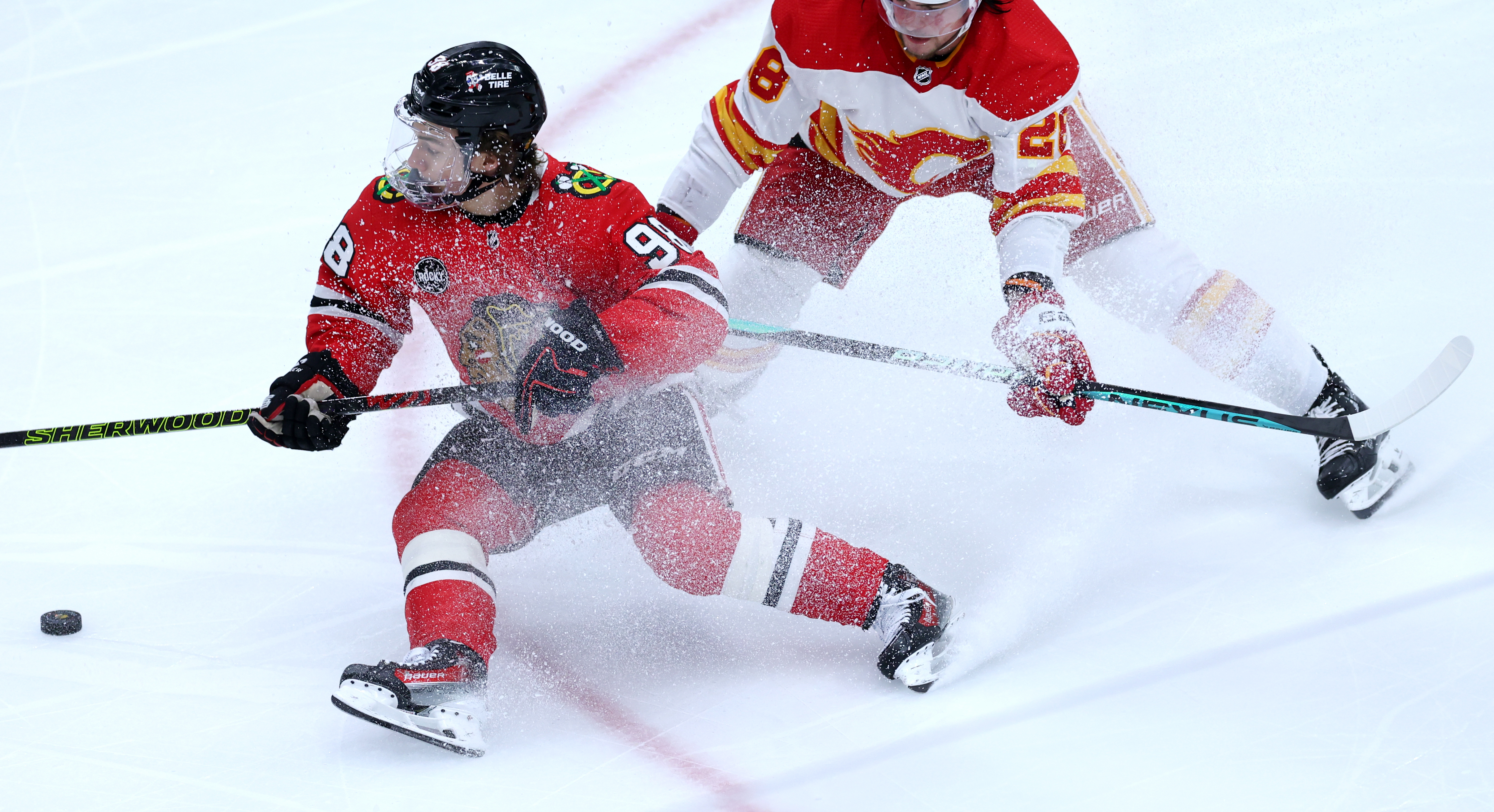 Chicago Blackhawks center Connor Bedard (98) makes a spin move as he slips on the ice in the second period of a game against the Calgary Flames at the United Center in Chicago on March 26, 2024. (Chris Sweda/Chicago Tribune)
