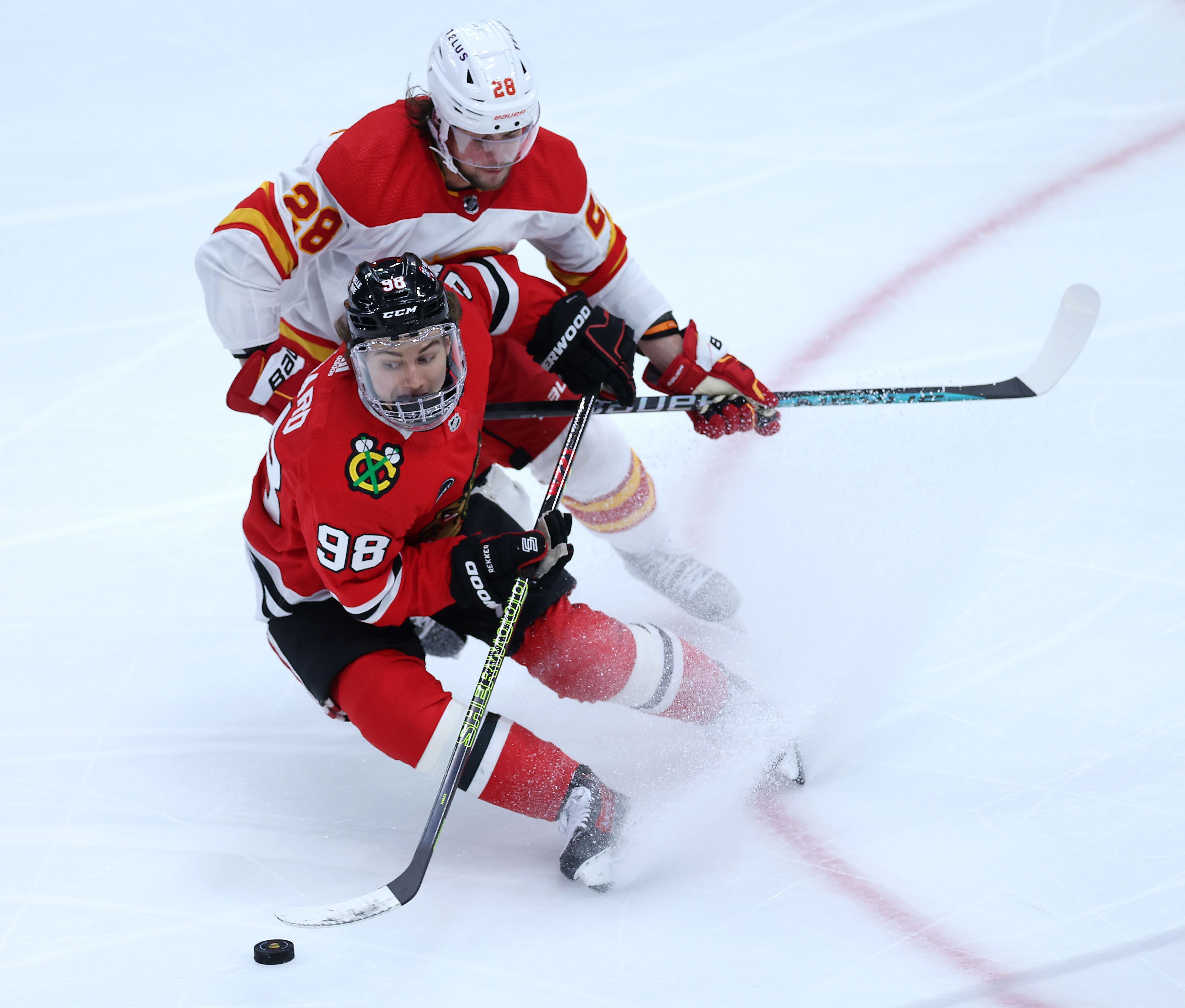 Chicago Blackhawks center Connor Bedard (98) makes a spin move before slipping on the ice in the second period of a game against the Calgary Flames at the United Center in Chicago on March 26, 2024. (Chris Sweda/Chicago Tribune)