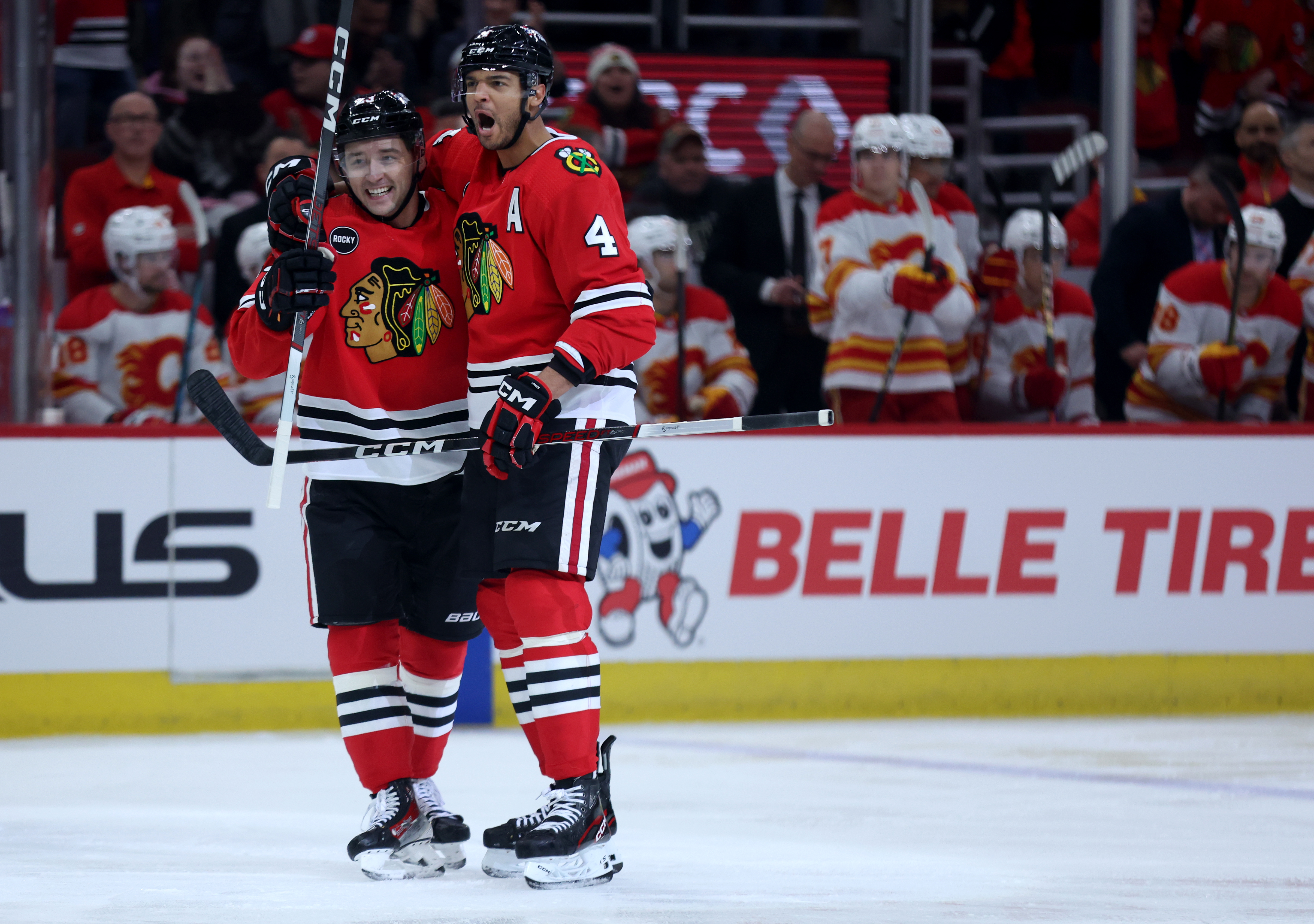 Chicago Blackhawks center Philipp Kurashev (left) and defenseman Seth Jones (4) celebrate after a goal by Jones in the first period of a game against the Calgary Flames at the United Center in Chicago on March 26, 2024. (Chris Sweda/Chicago Tribune)