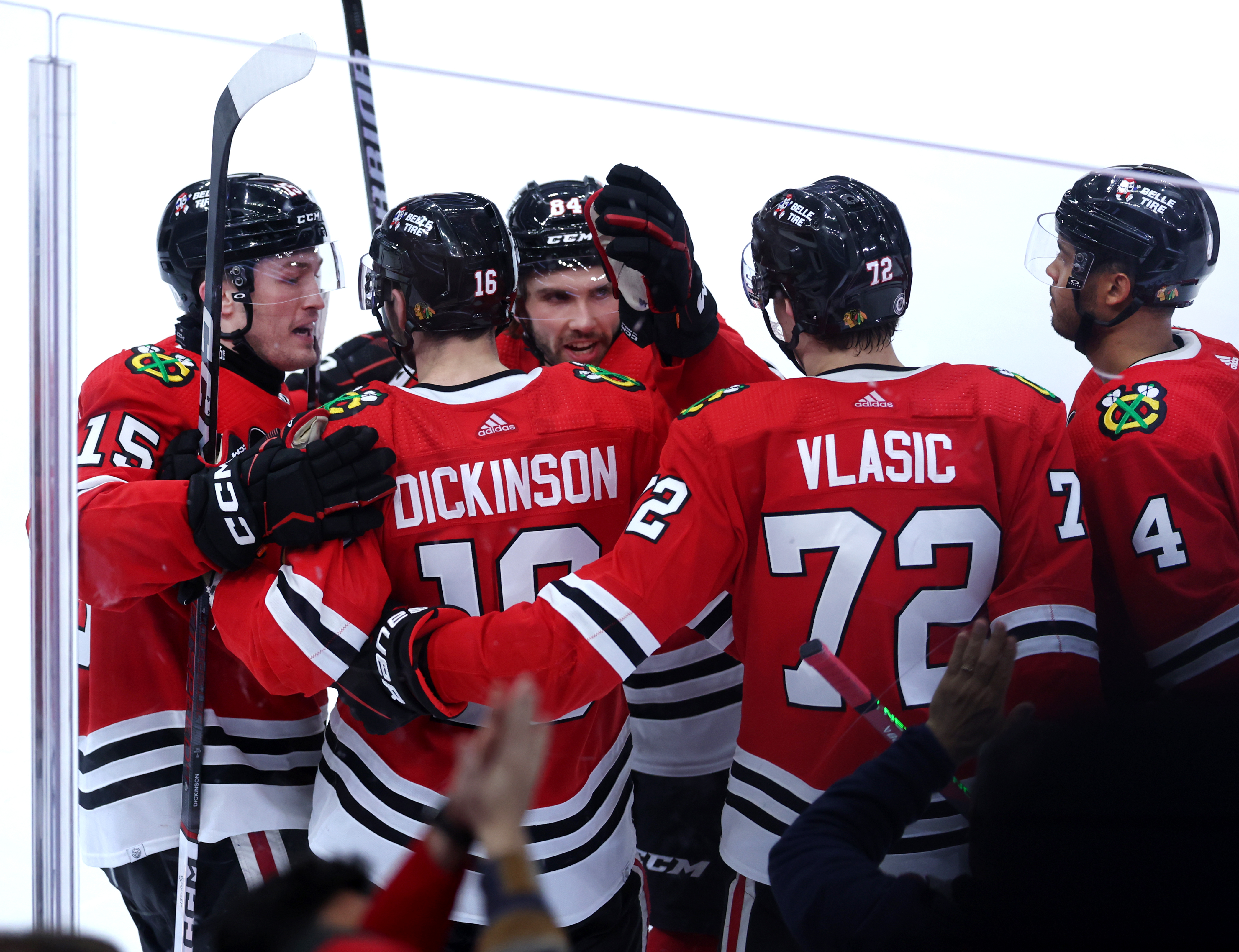 Chicago Blackhawks center Jason Dickinson (16) celebrates with his teammates after scoring a goal in the third period of a game against the Calgary Flames at the United Center in Chicago on March 26, 2024. (Chris Sweda/Chicago Tribune)
