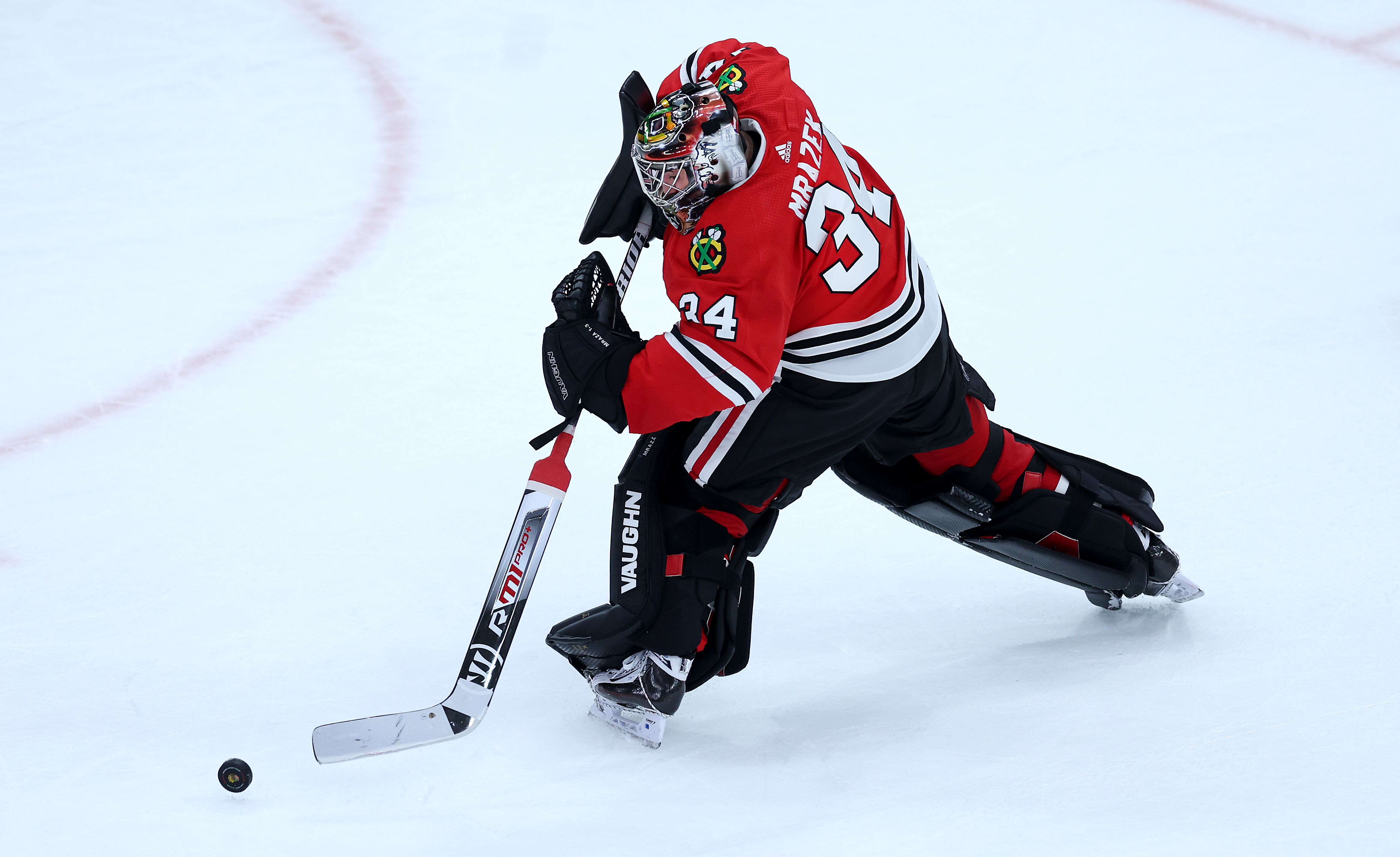 Chicago Blackhawks goaltender Petr Mrazek (34) passes the puck out to a teammate in the third period of a game against the Calgary Flames at the United Center in Chicago on March 26, 2024. (Chris Sweda/Chicago Tribune)