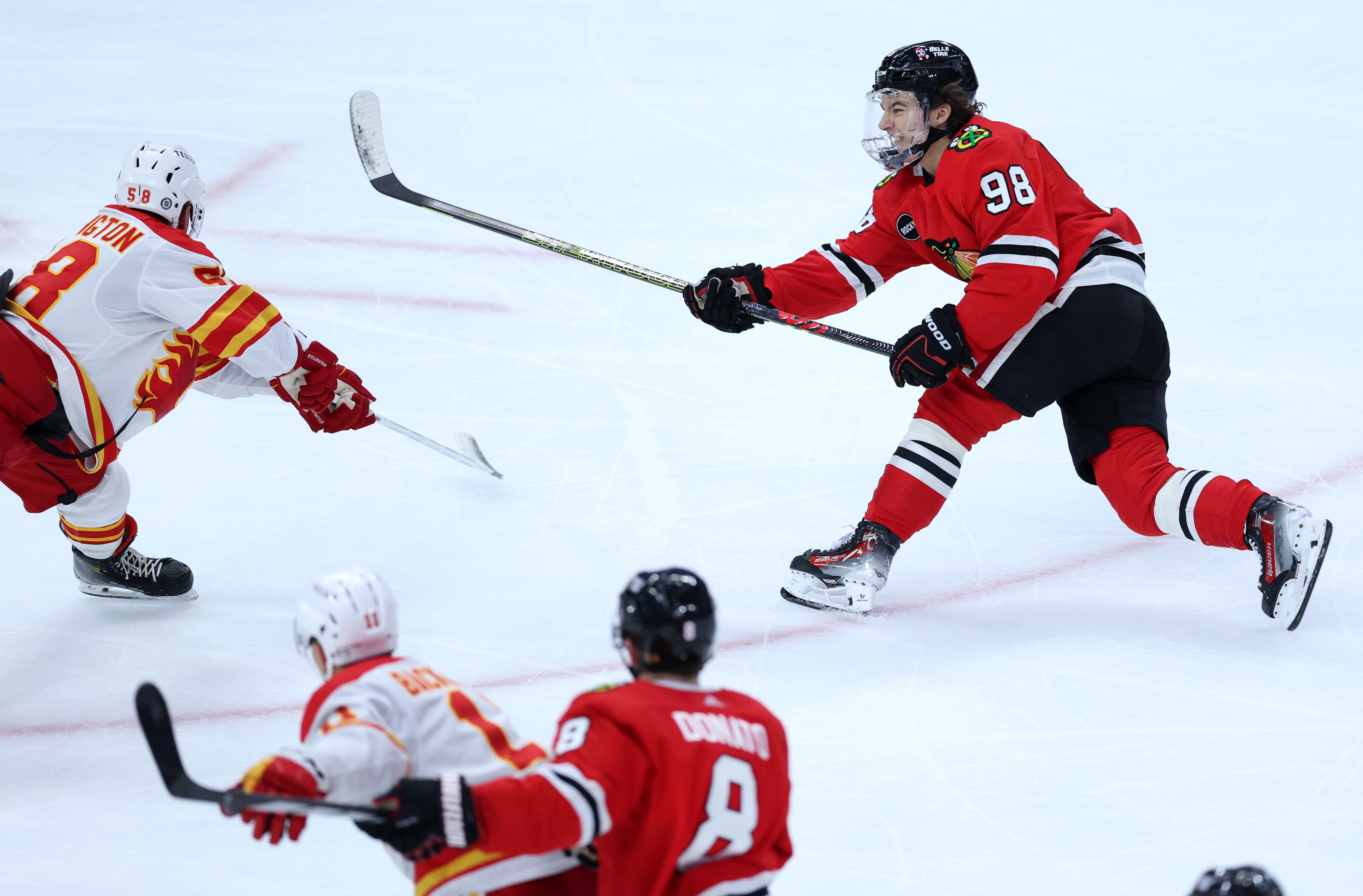 Chicago Blackhawks center Connor Bedard (98) follows through on a shot in the third period of a game against the Calgary Flames at the United Center in Chicago on March 26, 2024. (Chris Sweda/Chicago Tribune)