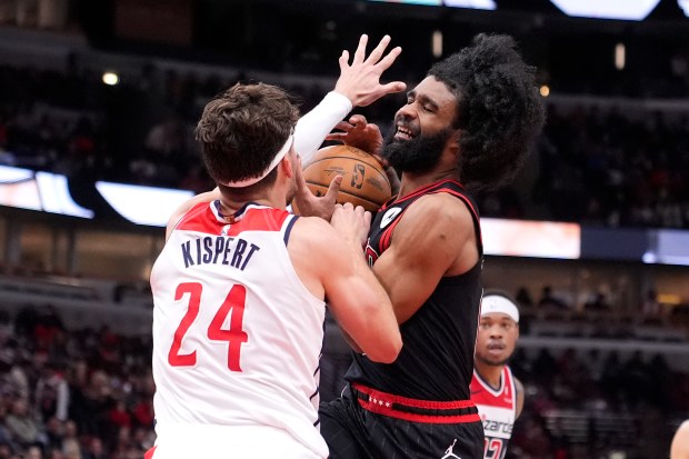 Chicago Bulls' Coby White collides with Washington Wizards' Corey Kispert during the second half of an NBA basketball game Monday, March 25, 2024, in Chicago. The Wizards won 107-105. (AP Photo/Charles Rex Arbogast)