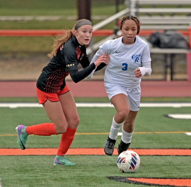 St. Charles East's Sophia Wollenberg battles for the ball with Burlington Central's Mekenzie Rogers. St. Charles East played Burlington Central to a 0-0 tie in girls soccer, Tuesday, March 26, 2024, in St. Charles, Illinois. (Jon Langham/for the Beacon-News)