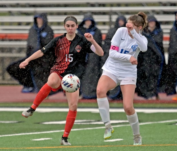 St. Charles East's Alli Saviano kicks the ball away from Burlington Central's Emerson Fry. St. Charles East played Burlington Central to a 0-0 tie in girls soccer, Tuesday, March 26, 2024, in St. Charles, Illinois.