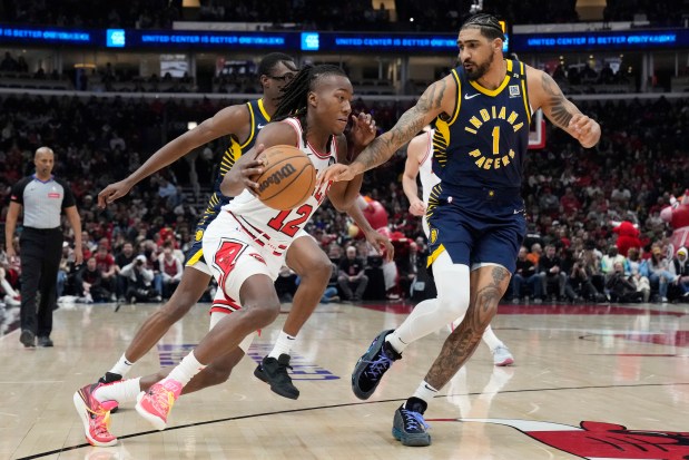 Bulls guard Ayo Dosunmu, left, drives against Pacers forward Obi Toppin on March 27, 2024, at the United Center. (Nam Y. Huh/AP)