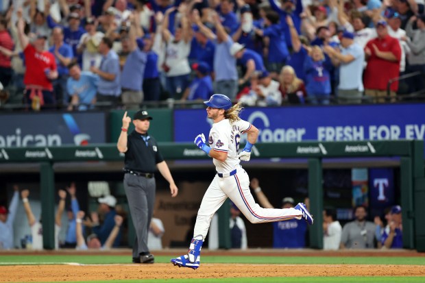 ARLINGTON, TEXAS - MARCH 28: Travis Jankowski #16 of the Texas Rangers runs the bases following a home run against the Chicago Cubs during the ninth inning of the Opening Day game at Globe Life Field on March 28, 2024 in Arlington, Texas. (Photo by Stacy Revere/Getty Images)