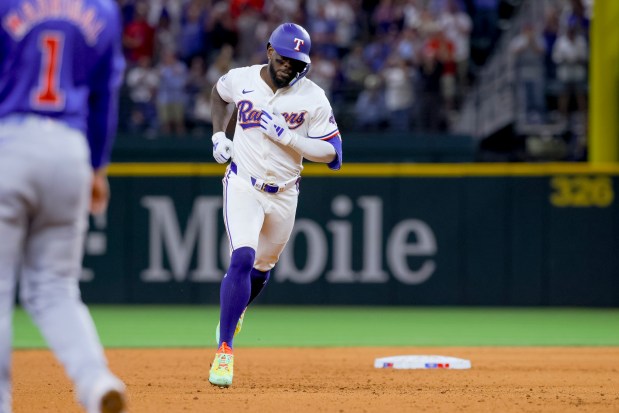 Texas Rangers' Adolis García runs the bases on a home run during the sixth inning of the team's baseball game against the Chicago Cubs, Thursday, March 28, 2024 in Arlington, Texas. (AP Photo/Gareth Patterson)