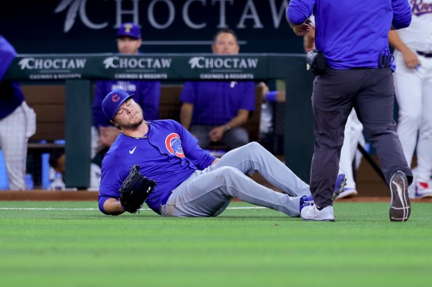 Cubs starting pitcher Justin Steele falls to the ground holding the back of his left leg during the fifth inning against the Rangers on March 28, 2024, in Arlington, Texas. (Gareth Patterson/AP)