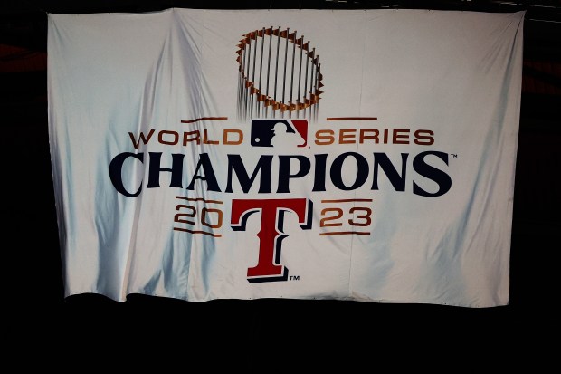 ARLINGTON, TEXAS - MARCH 28: The Texas Rangers unveil their 2023 World Series Champions banner prior to the Opening Day game against the Chicago Cubs at Globe Life Field on March 28, 2024 in Arlington, Texas. (Photo by Stacy Revere/Getty Images)