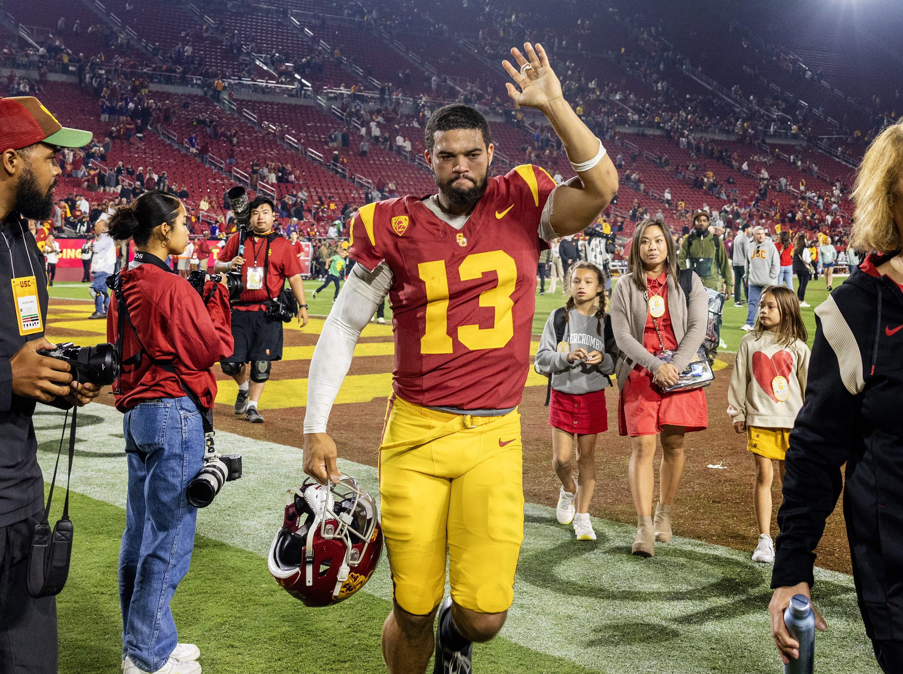 USC quarterback Caleb Williams waves to fans while leaving the...