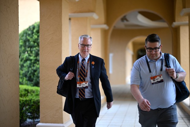 Chicago Bears Chairman George H. McCaskey, left, walks to an interview with the Bears Vice President of Communications Brandon Faber at the NFL owners meetings on March 26, 2024, in Orlando, Fla. (AP Photo/Phelan M. Ebenhack)