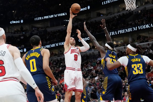 Bulls center Nikola Vučević shoots over Pacers forward Pascal Siakam and center Myles Turner on March 27, 2024, at the United Center. (Nam Y. Huh/AP)