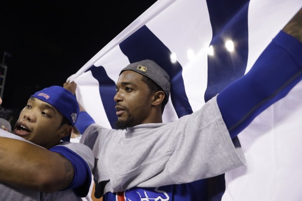Reliever Carl Edwards Jr. waves the "W" flag after the Cubs won the World Series on Nov. 3, 2016, in Cleveland. (Nuccio DiNuzzo/Chicago Tribune)